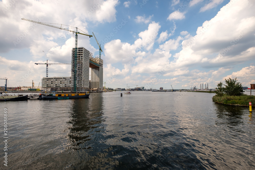 Construction of new appartments at the side of het IJ, seen from the Silodam Amsterdam, the Netherlands
