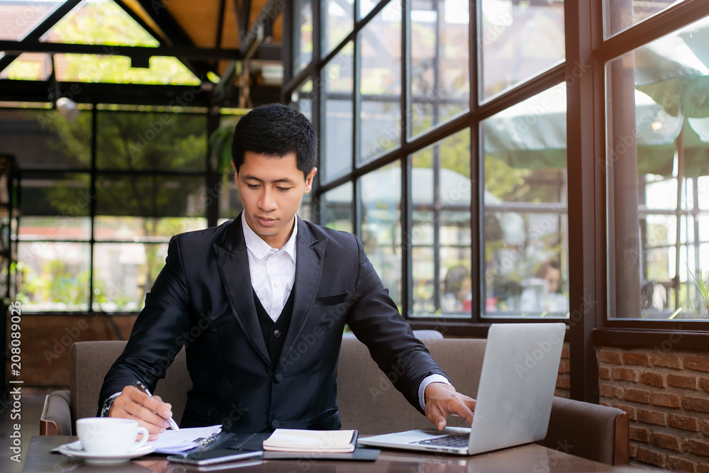 Business man working at office with laptop and documents on his desk, consultant lawyer concept Business man working at office with laptop and documents on his desk, consultant lawyer concept