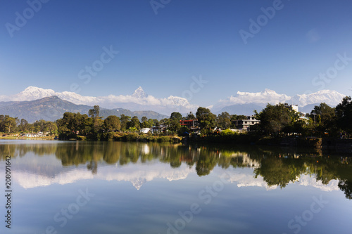 Reflection of Annapurna 8000m mountain range and Machapuchare (Fishtail mountain) 6993m, Pokara, Nepal, Himalayas photo