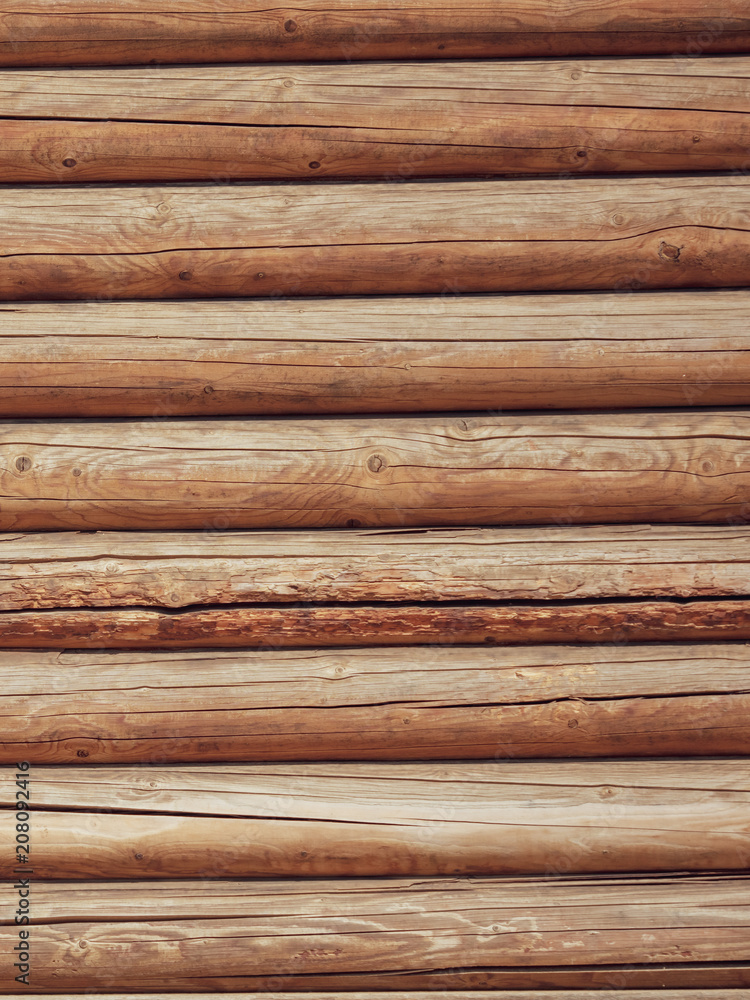 Logs on the wall with a log frame as a background Logs on the wall with a log frame as a background