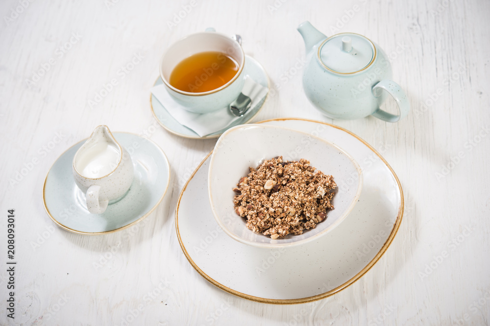 Healthy breakfast, cereals and milk with tea over white Healthy breakfast, cereals and milk with tea over white
