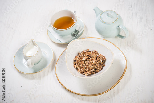 Healthy breakfast  cereals and milk with tea over white