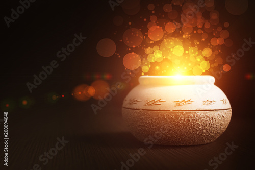 magic pot with gold on a dark background photo