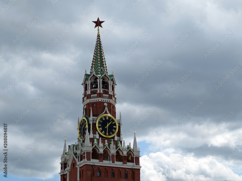 Moscow Kremlin tower on background of dark storm sky. Kremlin Red star and chimes, tourist landmark on Red square Moscow Kremlin tower on background of dark storm sky. Kremlin Red star and chimes, tourist landmark on Red square
