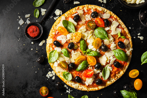 Traditional italian pizza on dark table