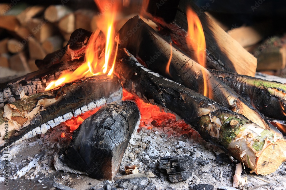 Close-up of flames of a campfire burning with wood and glowing coals Close-up of flames of a campfire burning with wood and glowing coals