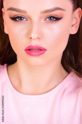 sensual woman with long hair on pink background. sensual woman with makeup on pretty face