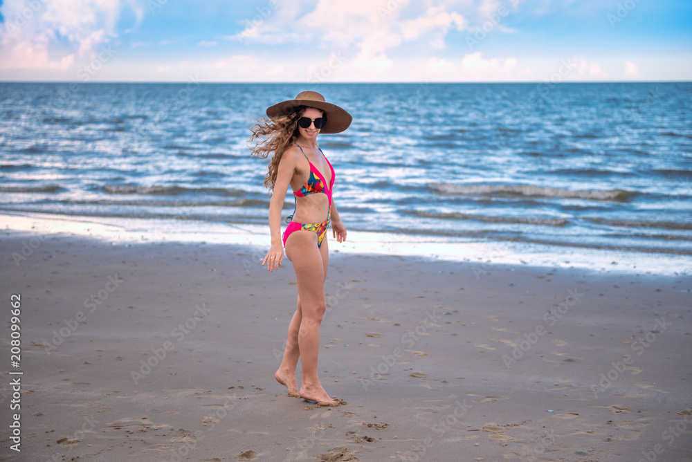 Portrait happy woman with long blonde curly hair on the beach with enjoying and refreshing, summer beach relaxing time concept. Portrait happy woman with long blonde curly hair on the beach with enjoying and refreshing, summer beach relaxing time concept.