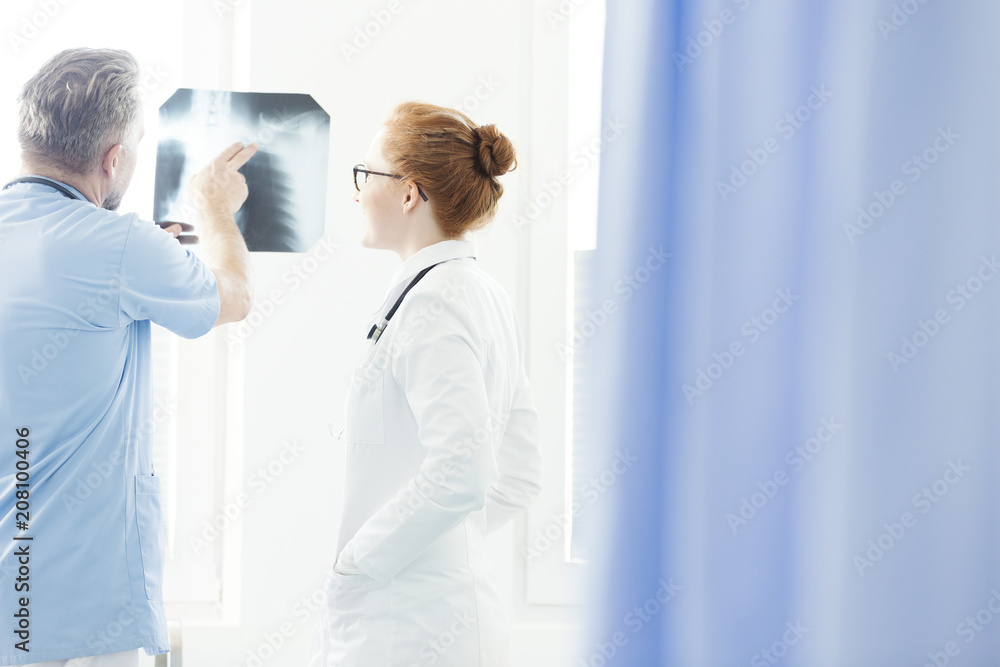 Pulmonologist consulting X-ray image Pulmonologist consulting X-ray image