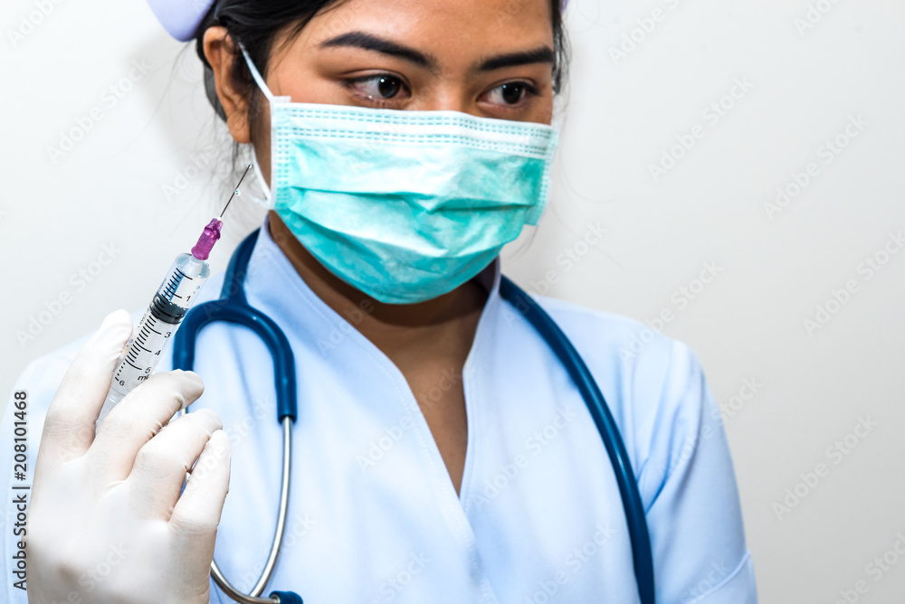 Nurse holding medical syringe with needle in ampule getting ready for patient injection. Nurse holding medical syringe with needle in ampule getting ready for patient injection.