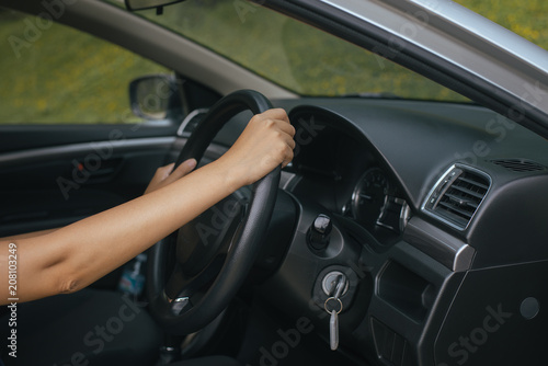 Hands of female driver on steering wheel,Woman driving a car