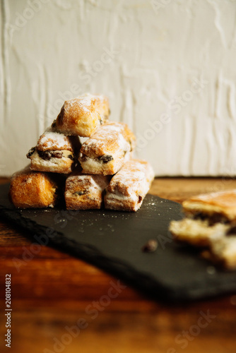 Strudel Apple and sugar powder. Biscuit from the puffed Test on the Gray Background. Dessert with Fruits.Copy space for Text. selective focus.