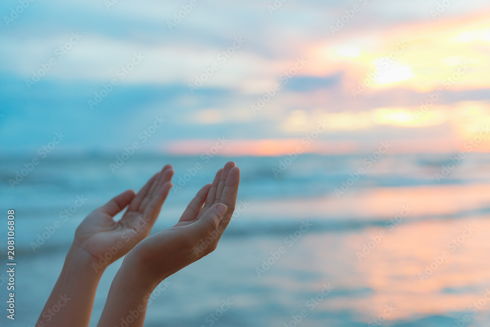 Closeup woman hands praying for blessing from god during sunset background. Hope concept. Closeup woman hands praying for blessing from god during sunset background. Hope concept.
