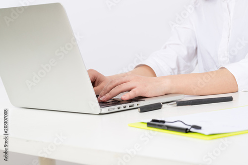 Business young woman typing on laptop computer at office 