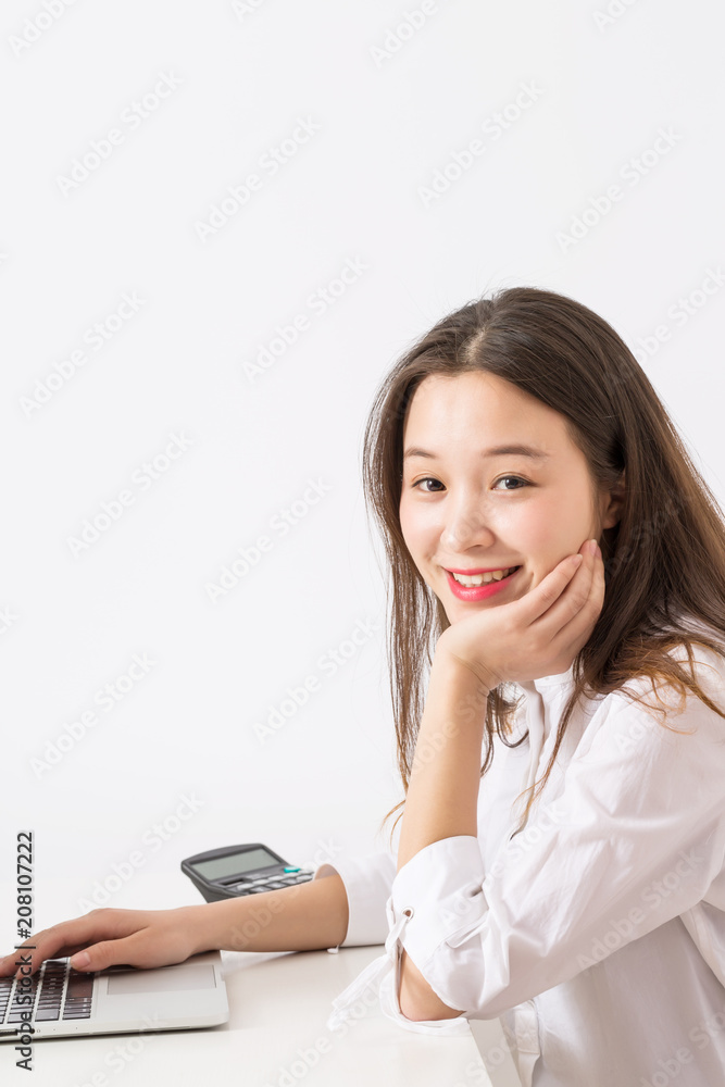 Business woman with laptop computer at office, Close up of smiling young woman working. Business woman with laptop computer at office, Close up of smiling young woman working.