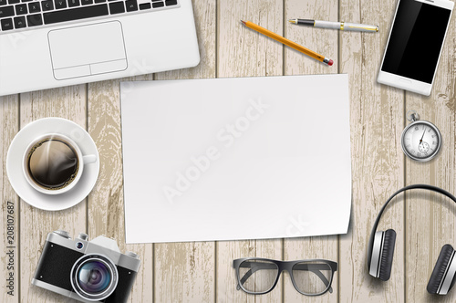 Blank white sheet of paper on a wooden table.