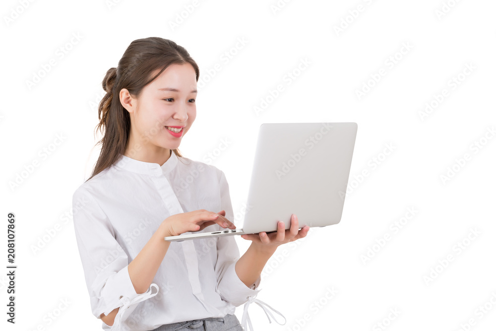 Young woman standing on white holding a laptop computer. Young businesswoman with laptop isolated on white and standing