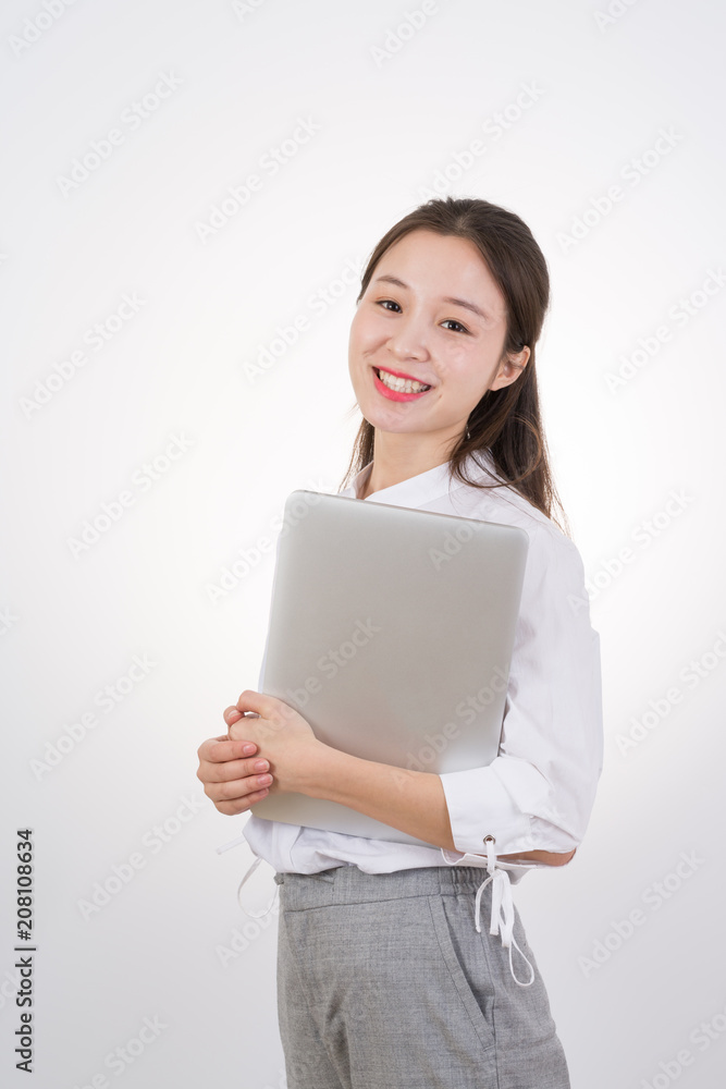 Smiling asian woman in business clothes holding laptop computer Smiling asian woman in business clothes holding laptop computer