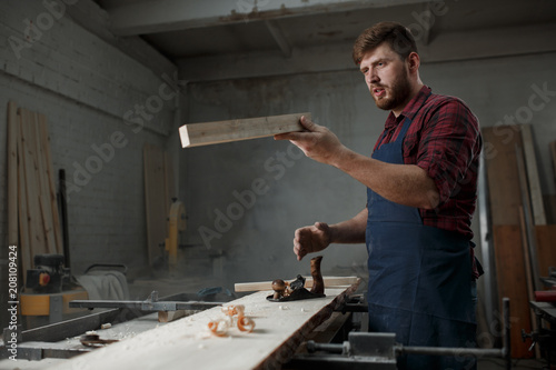 Portrait Male Master carpenter apron in his workshop. Small business