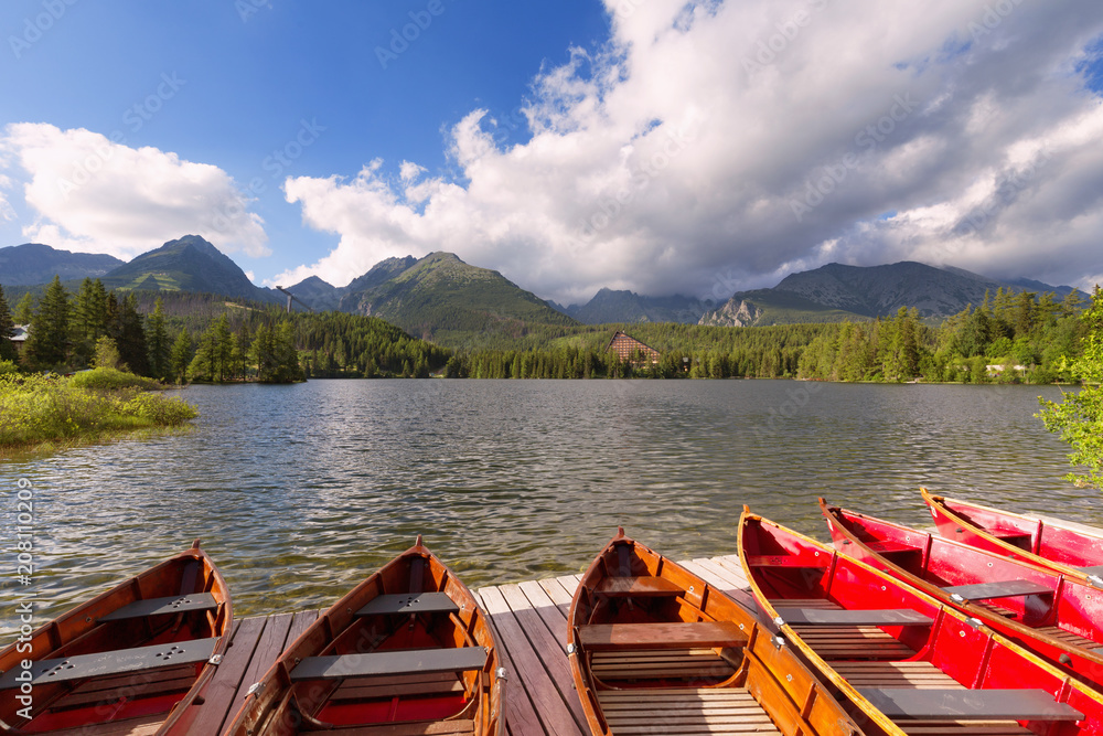 Panorama mountain lake Strbske Pleso in the Tatra mountains. Summers colors and boat for swimming