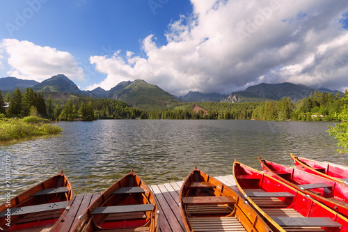 Panorama mountain lake Strbske Pleso in the Tatra mountains. Summers colors and boat for swimming