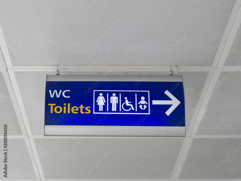 Sign at the airport indicating the location of the toilet for all categories of passengers.