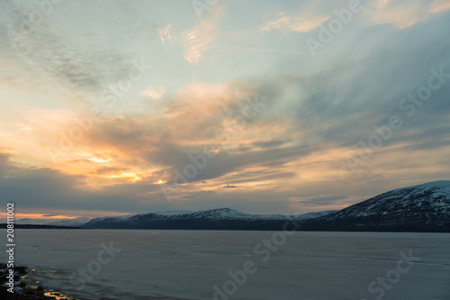 The frozen Tornetr  sk Lake in the Abisko National Park at sunset   Lapland  Sweden