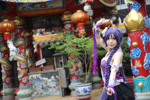Portrait of asian young woman dancing with purple Chinese dress cosplay with temple © Oran Tantapakul