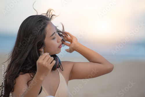 Portrait of Asian woman with happiness and enjoying on the beach, traveling and relaxing time concept.