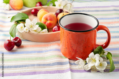 Obraz na płótnie Summer still life with berry tea, ripe apricots, juicy cherries and apple blossoms w salonie