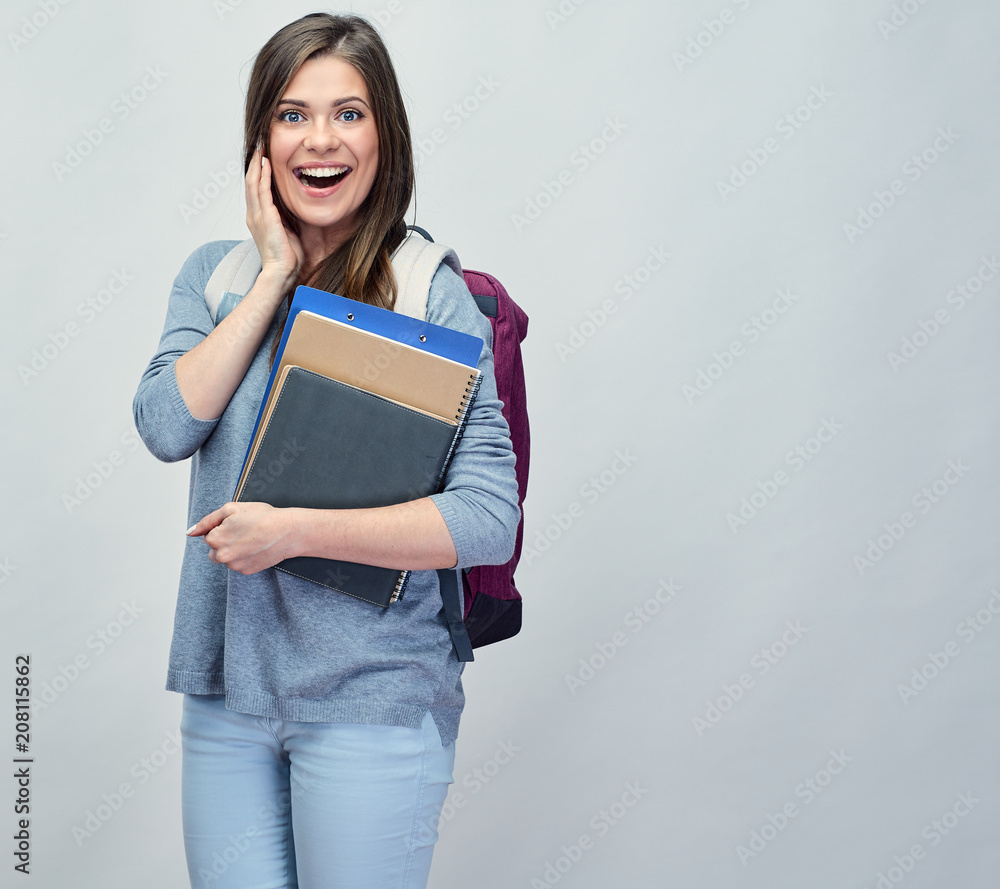 Obraz premium Smiling student woman with backpack holding books, notebooks.