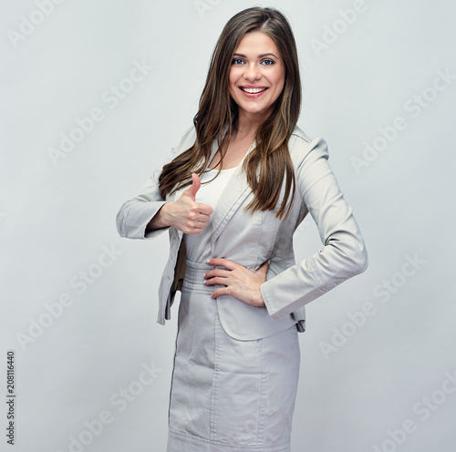 Smiling business woman showing thumb up.