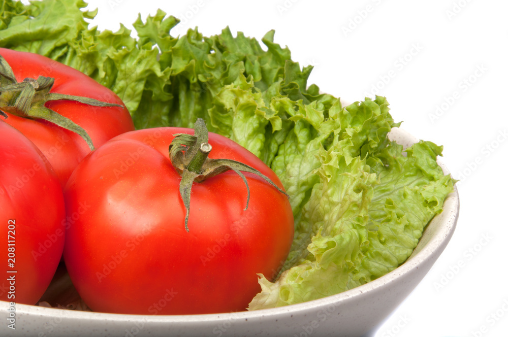 tomatoes with lettuce on dish isolated on the white tomatoes with lettuce on dish isolated on the white