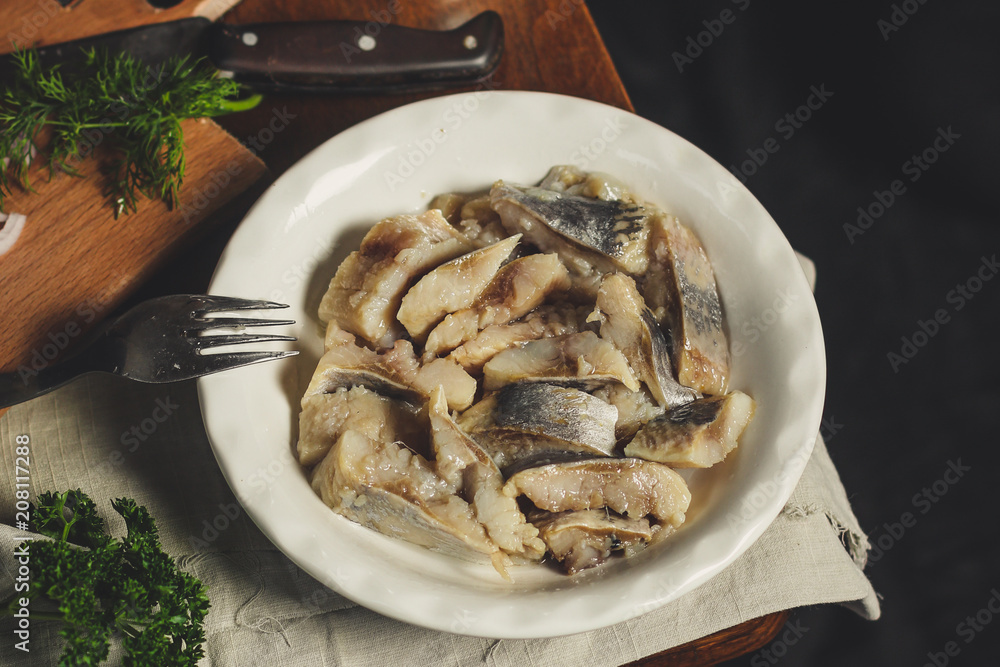 tasty herring. seafood on a plate (a herring fish in marinade) - cuisine. Food background tasty herring. seafood on a plate (a herring fish in marinade) - cuisine. Food background