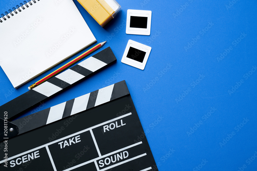 movie clapper on blue background ; film, cinema and video photography concept