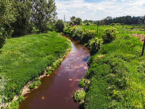 dirty brown river. pollution concept. green riverside