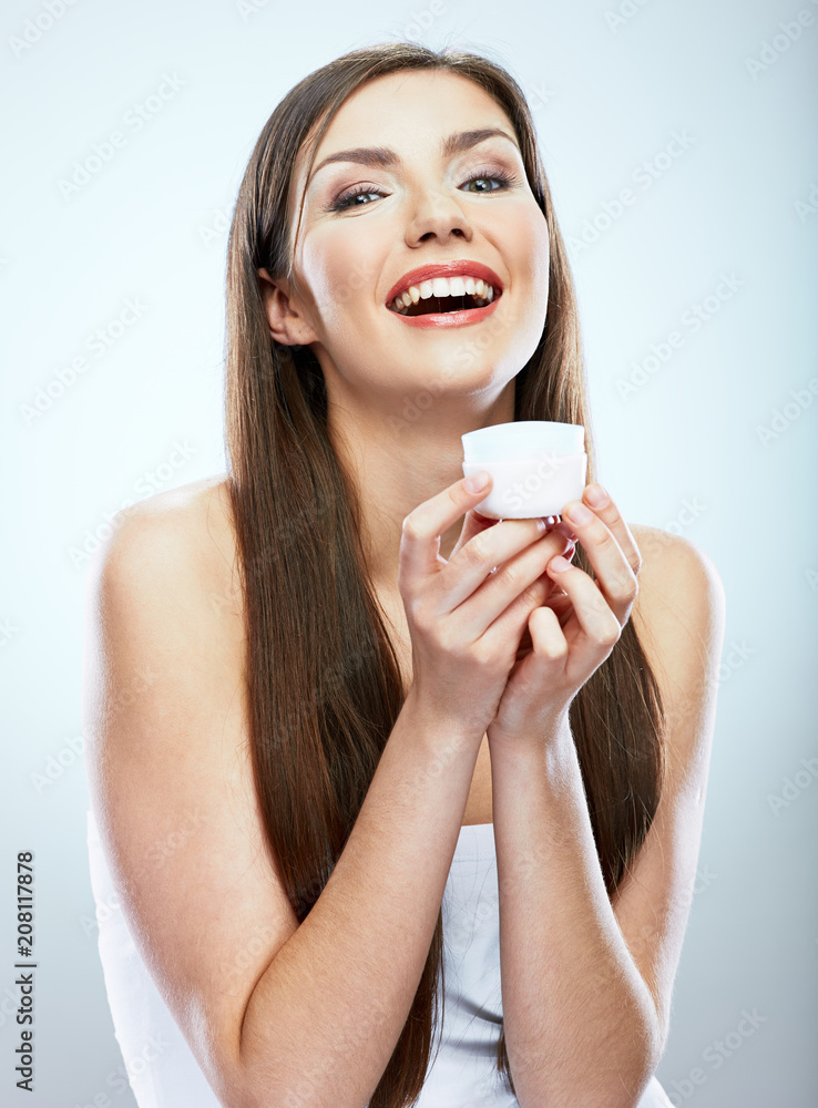 Smiling girl holding beauty skin care cream in glass jar. Smiling girl holding beauty skin care cream in glass jar.