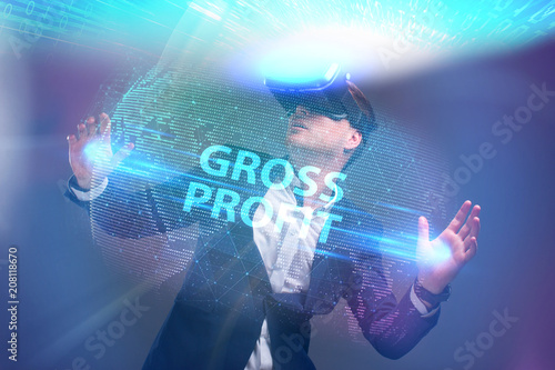 Business, Technology, Internet and network concept. Young businessman working in virtual reality glasses sees the inscription: Gross profit