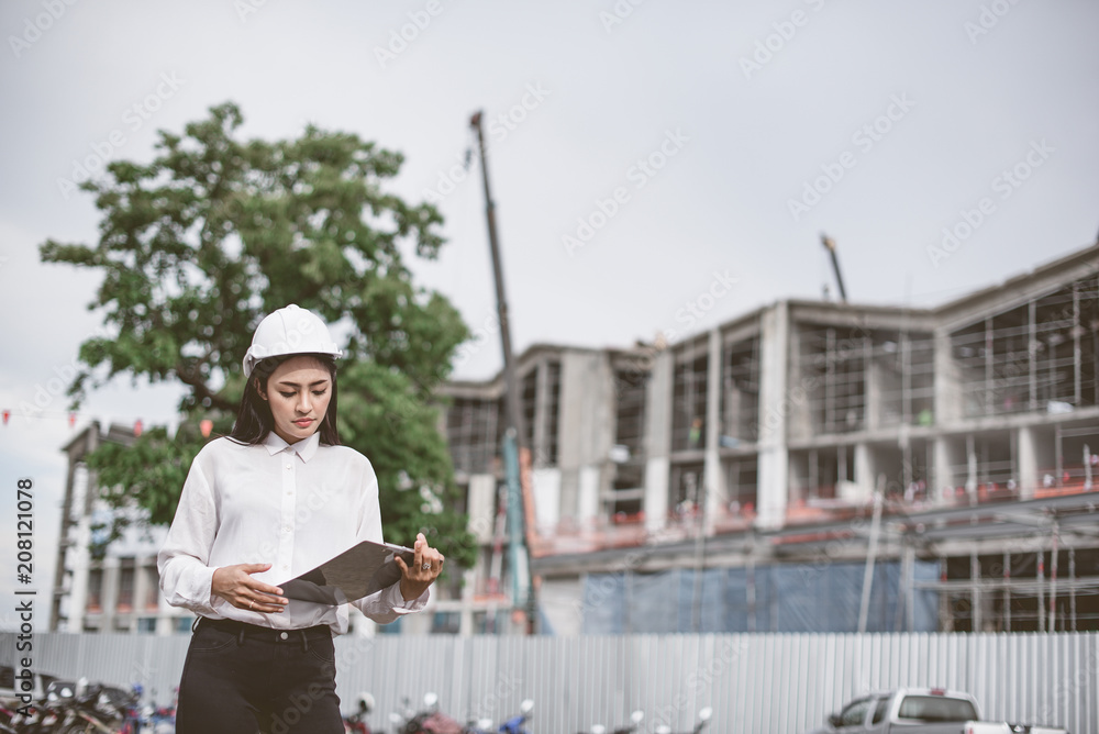 Asian women worker and engineer electrician work safety control at power plant energy industry