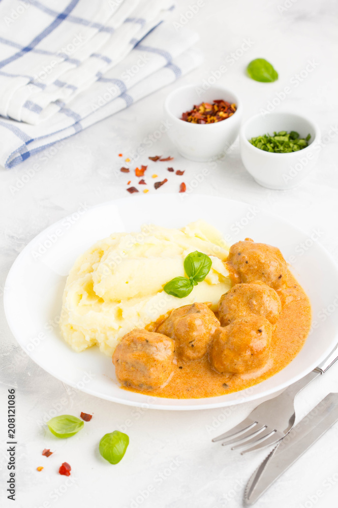 Meatballs with mashed potatoes, creamy tomato sauce, classic delicious food
