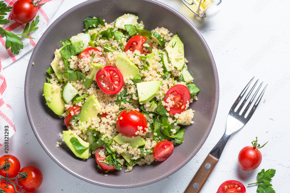 Quinoa salad with spinach, avocado and tomatoes top view. Quinoa salad with spinach, avocado and tomatoes top view.