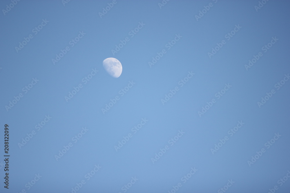 a picture of the moon on a clear blue sky a picture of the moon on a clear blue sky