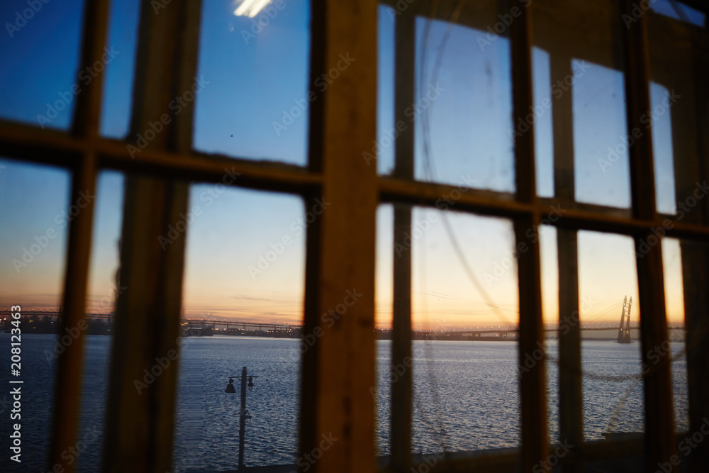 View of beautiful sunset over river from window of workshop. View of beautiful sunset over river from window of workshop.