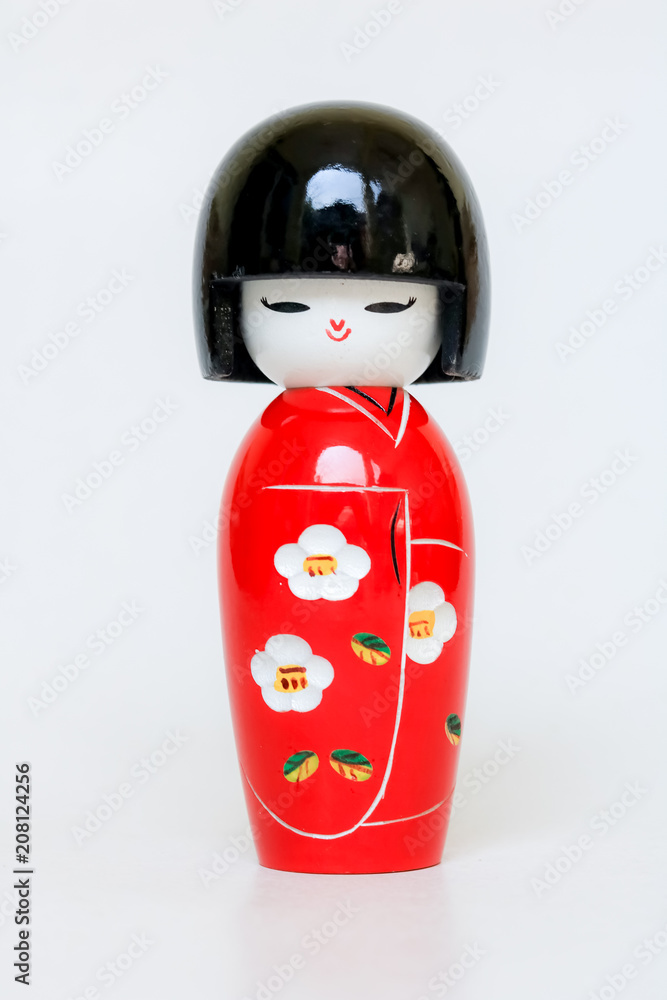 Obraz premium Japanese Wooden Doll Wearing A Red Kimono