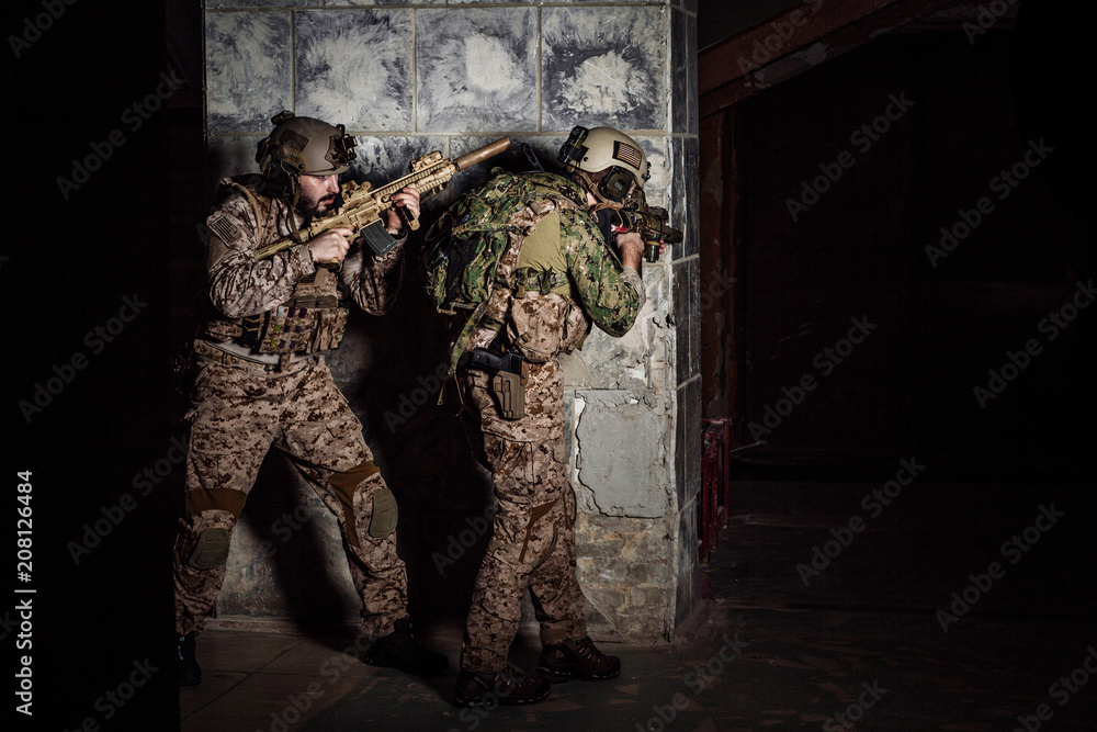 soldiers or private military contractors holding rifle. Image on a black background. war, army, weapon, technology and people concept soldiers or private military contractors holding rifle. Image on a black background. war, army, weapon, technology and people concept