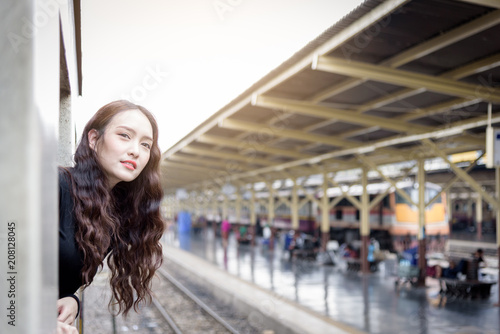 Asian woman traveler has exciting with traveling by train at Hua Lamphong station at Bangkok, Thailand.