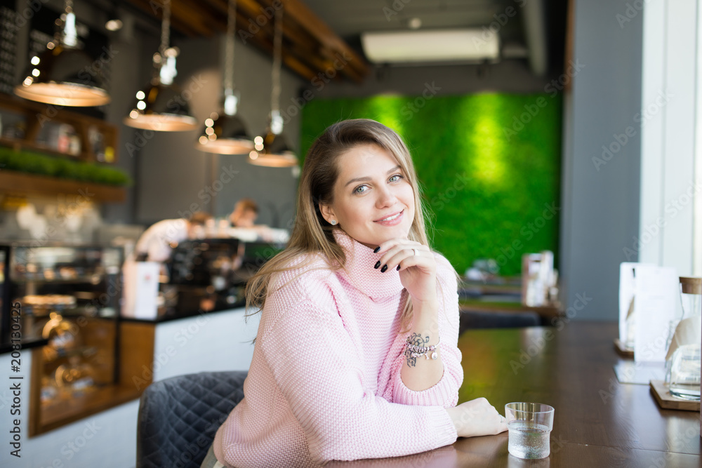 attractive woman in cafe smiling attractive woman in cafe smiling