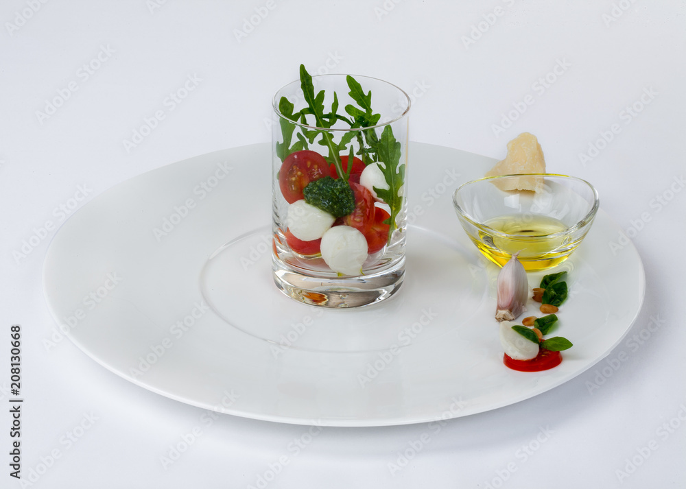 Mozzarella cheese with tomatoes in a glass. Mozzarella cheese with tomatoes in a glass.