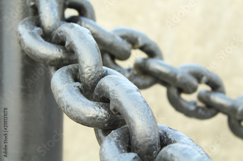 Black thick metal chain for the fence. Close-up. Background.