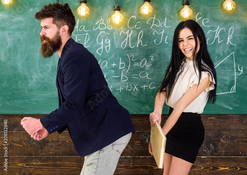 Fotografie Student lady slapping on teachers buttocks with book